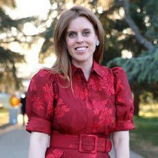 Princess Beatrice wearing a red puff sleeve dress with a belt