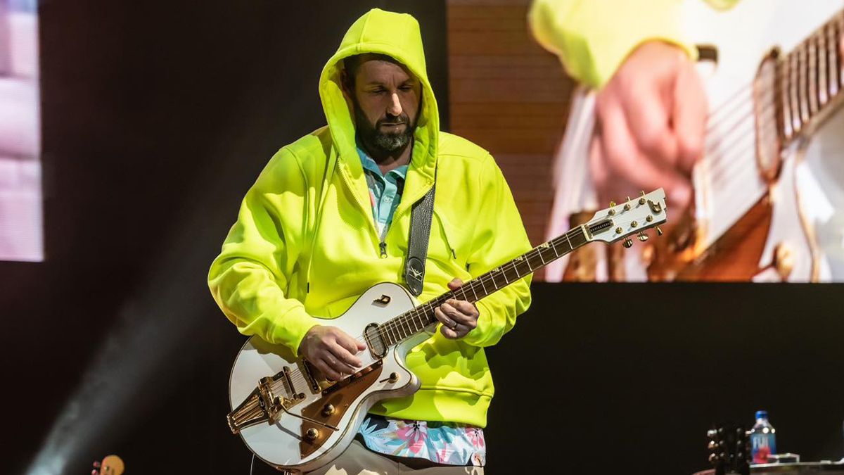 Adam Sandler playing guitar