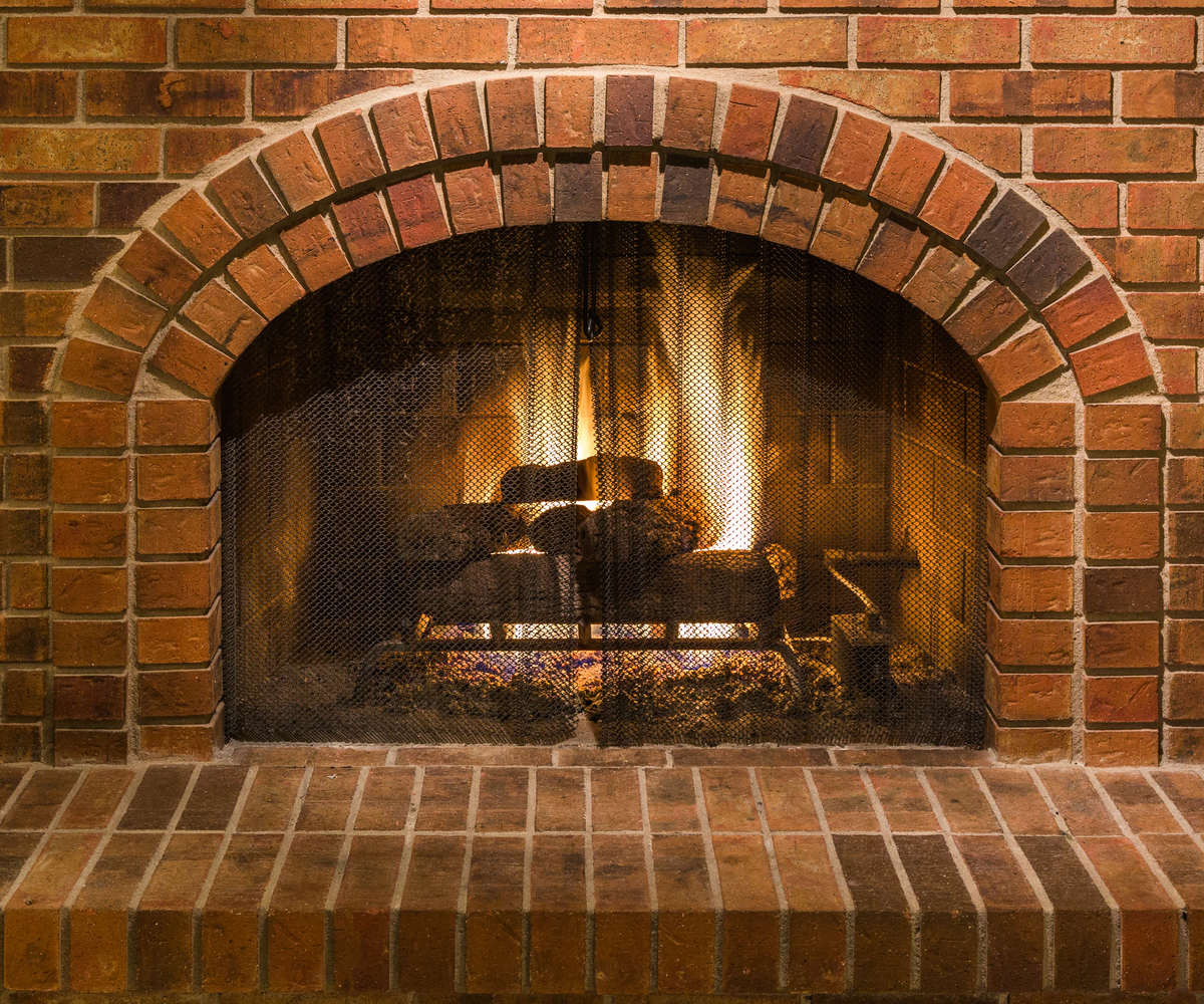 a fireplace made from recessed brickwork, with the mortar set back from the faces of the bricks