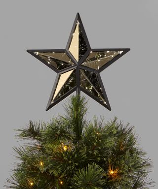 A black-framed, mirrored five-point, star-shaped, Christmas tree topper