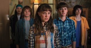 Eleven, Mike, Will and friends stare into the distance in an official image from Stranger Things season 4