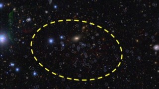 A black background with glowing white blue and yellow orbs scattered across it, some within a yellow dotted circle
