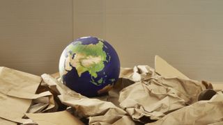 A globe of the Earth in recycled packaging. 