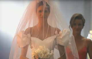 A still from the November Rain video showing Stephanie Seymour walking down the aisle