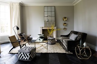 Grey living room with black velvet sofa