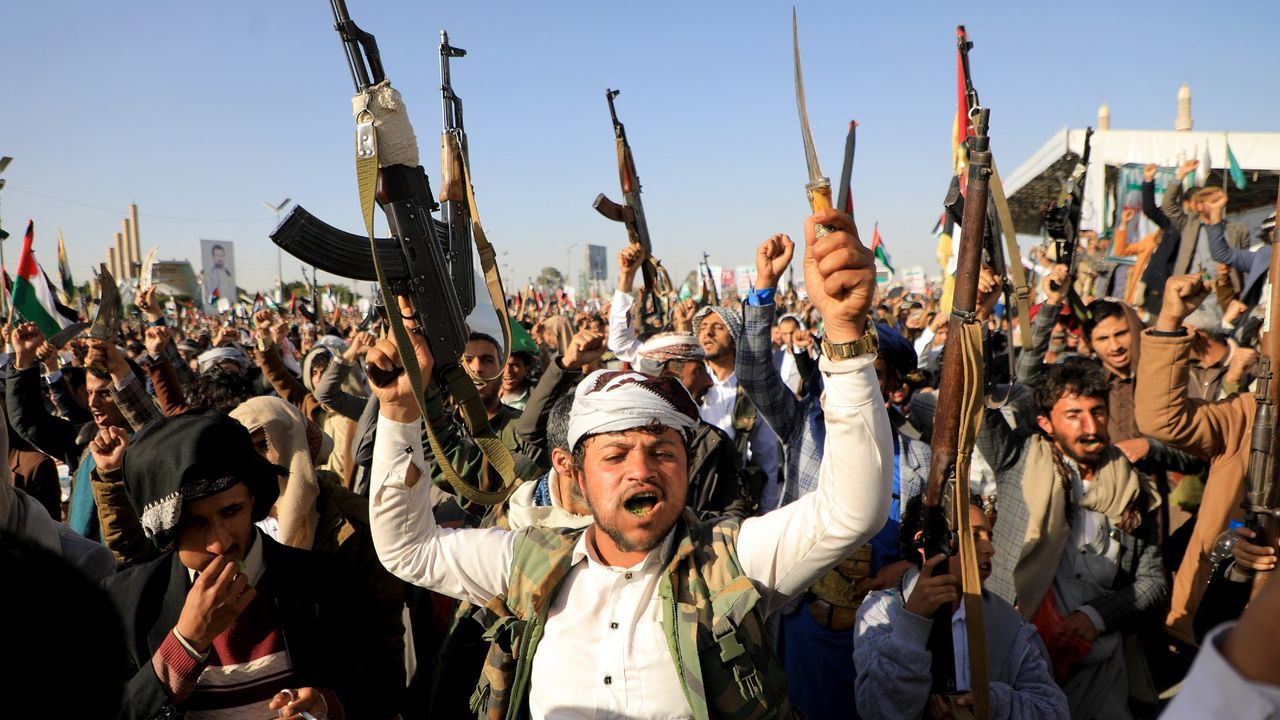 Houthi fighters brandish weapons during a protest in Yemen&#039;s capital city Sanaa