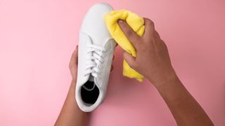 cleaning white shoes with a cloth