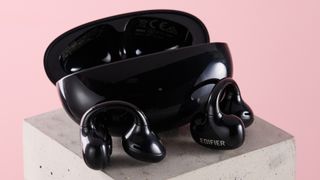 Edifier LolliClip open ear headphones leaning against charging case