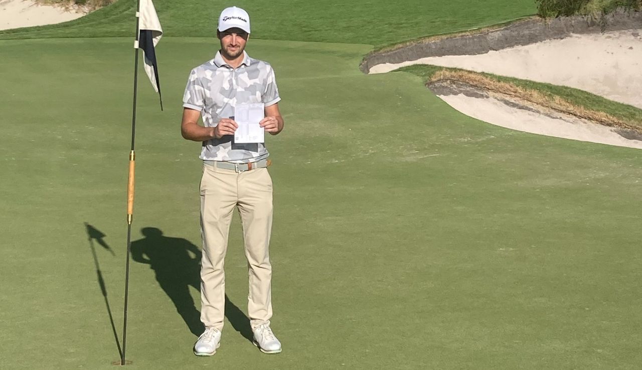 Golfer poses with scorecard