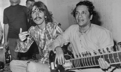 George Harrison with Indian musician Ravi Shankar in August 1967: Harrison and Shankar organized the Concert for Bangladesh, the first rock star charity performance of its kind.