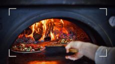 Person using a pizza oven to cook fresh pizza to support a guide on how to clean a pizza oven