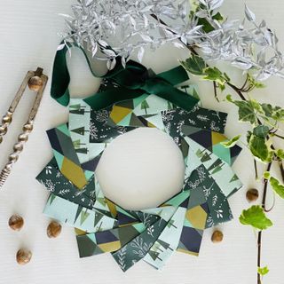 green origami paper wreath with festive patterned papers