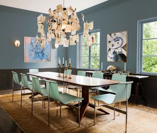 Dining room with blue walls and green dining chairs