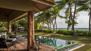 Terrace and pool at Four Seasons Desroches Island.