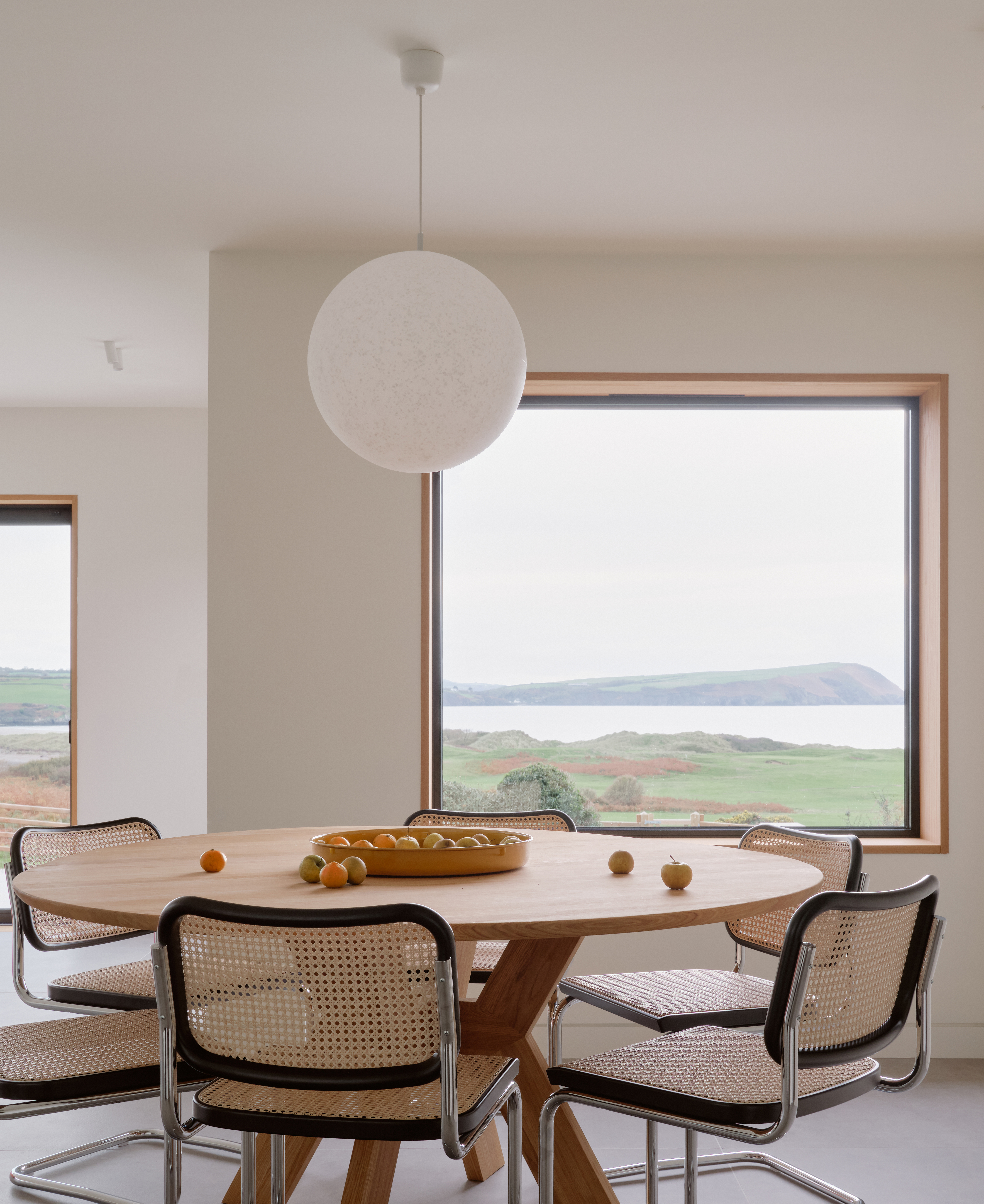 view of a welsh cottage or bungalow type building facing the sea and redesigned in a fairly minimalist, contemporary way