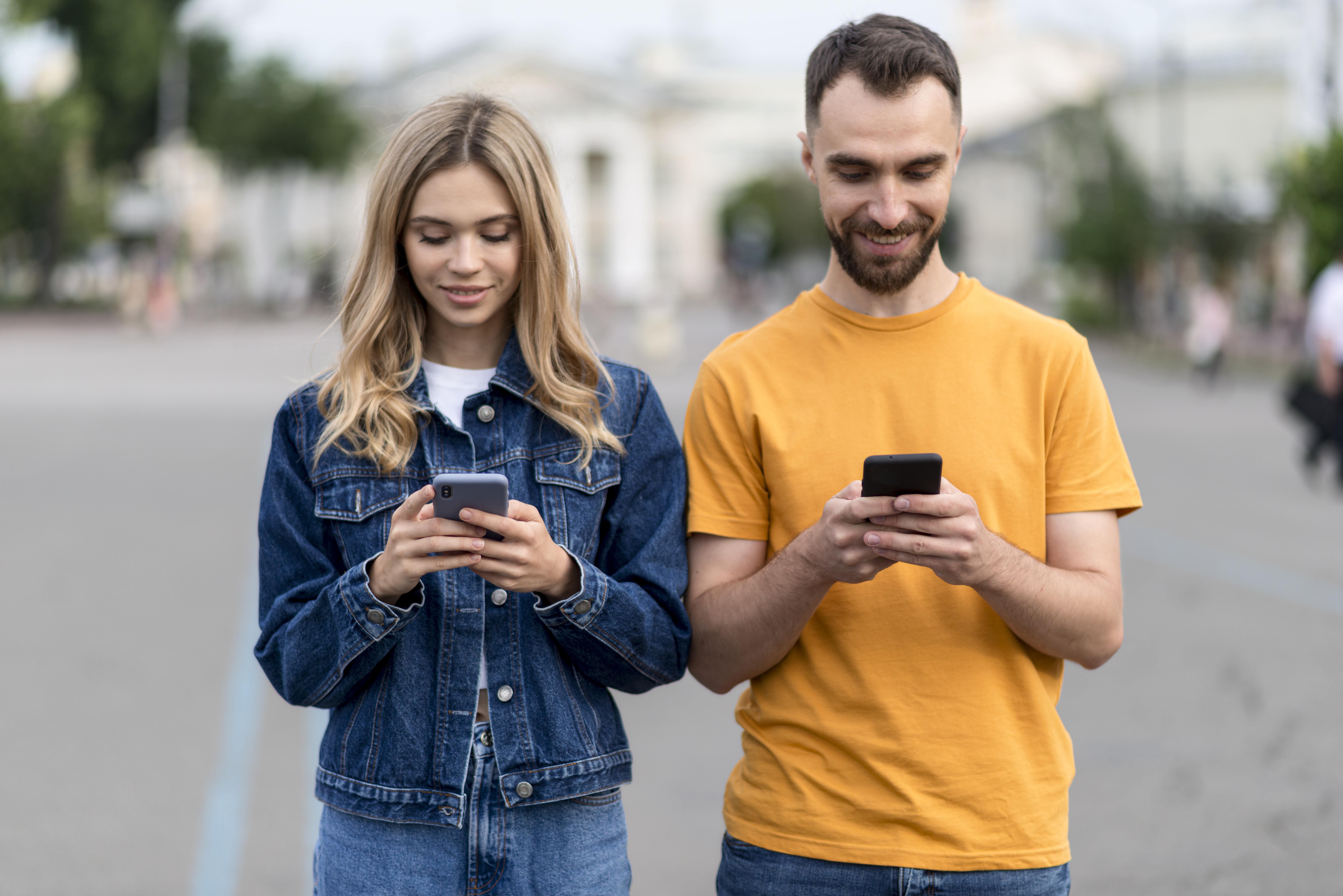 Man and woman on phone smiling down