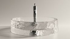 glass washbasin with brushed steel tap