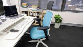 Steelcase Personality Plus office chair in blue placed at a desk