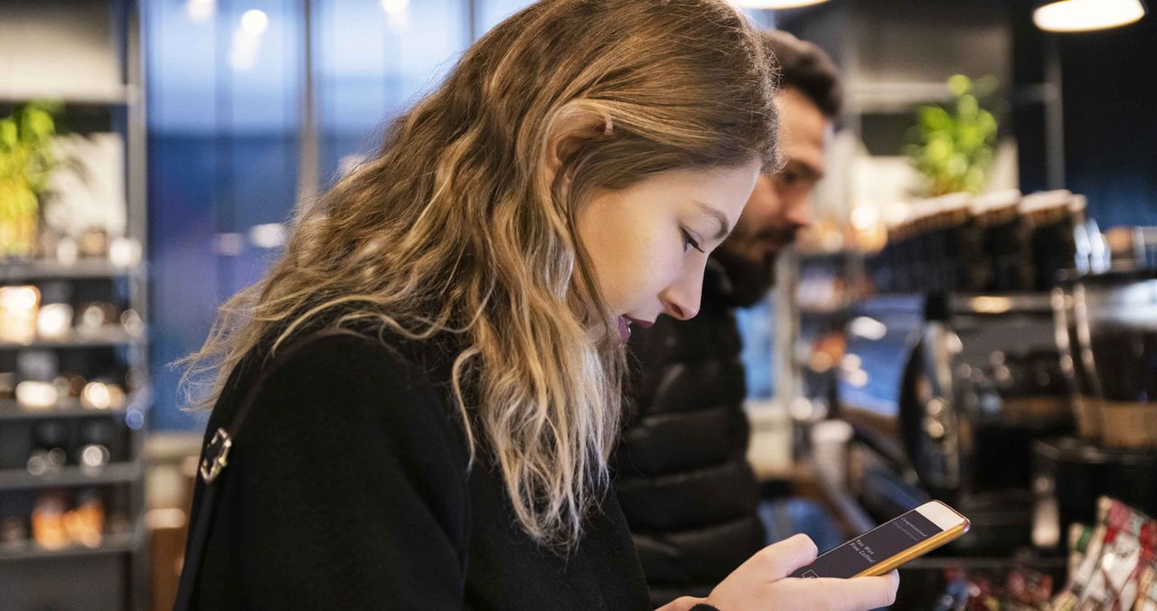 woman in store testing a new phone