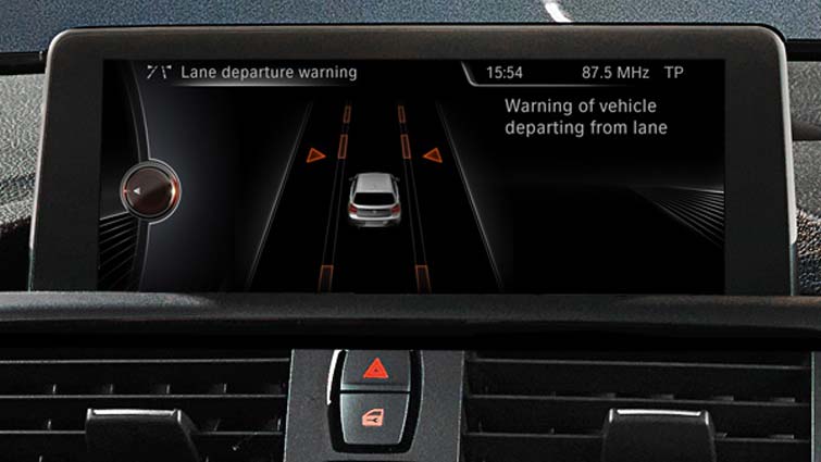 The Cadillac STS side mirror warns drivers of dangers lurking in blind spots before they change lanes. Credit: BMW
