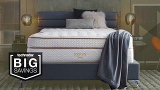 The Saatva Classic Mattress shown on a stylish gray fabric bed frame