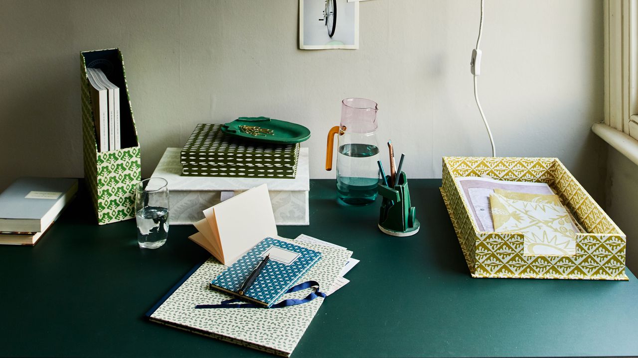 desk with paper tray and stationery