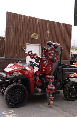Team Tartan Rescue's CHIMP robot exits the vehicle during the DARPA Robotics Challenge on June 5, 2015.