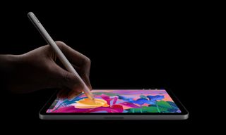 Someone writing on the iPad Mini 7 using the Apple Pencil Pro