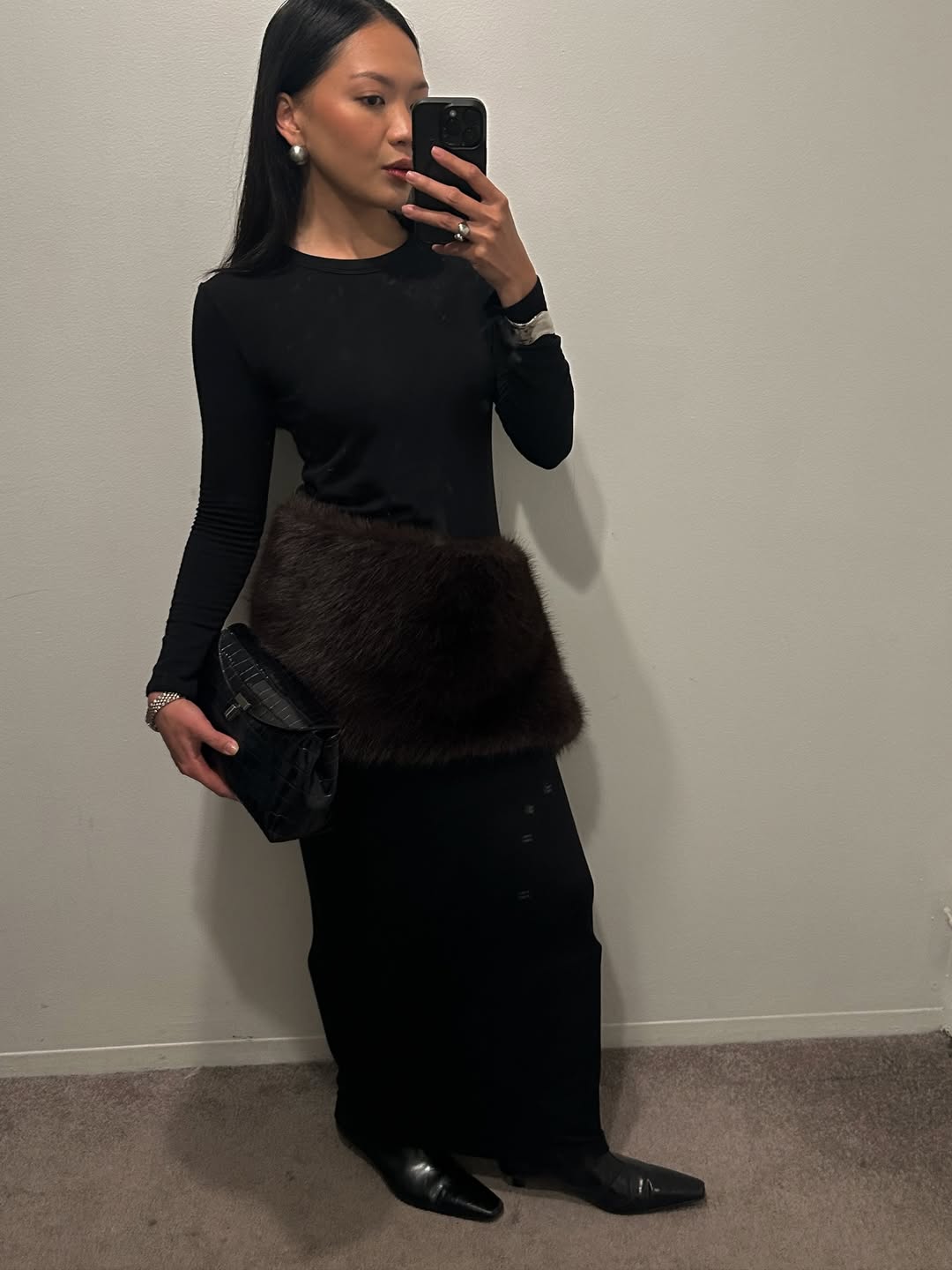 Dawn Tan wearing a faux-fur scarf as a belt.