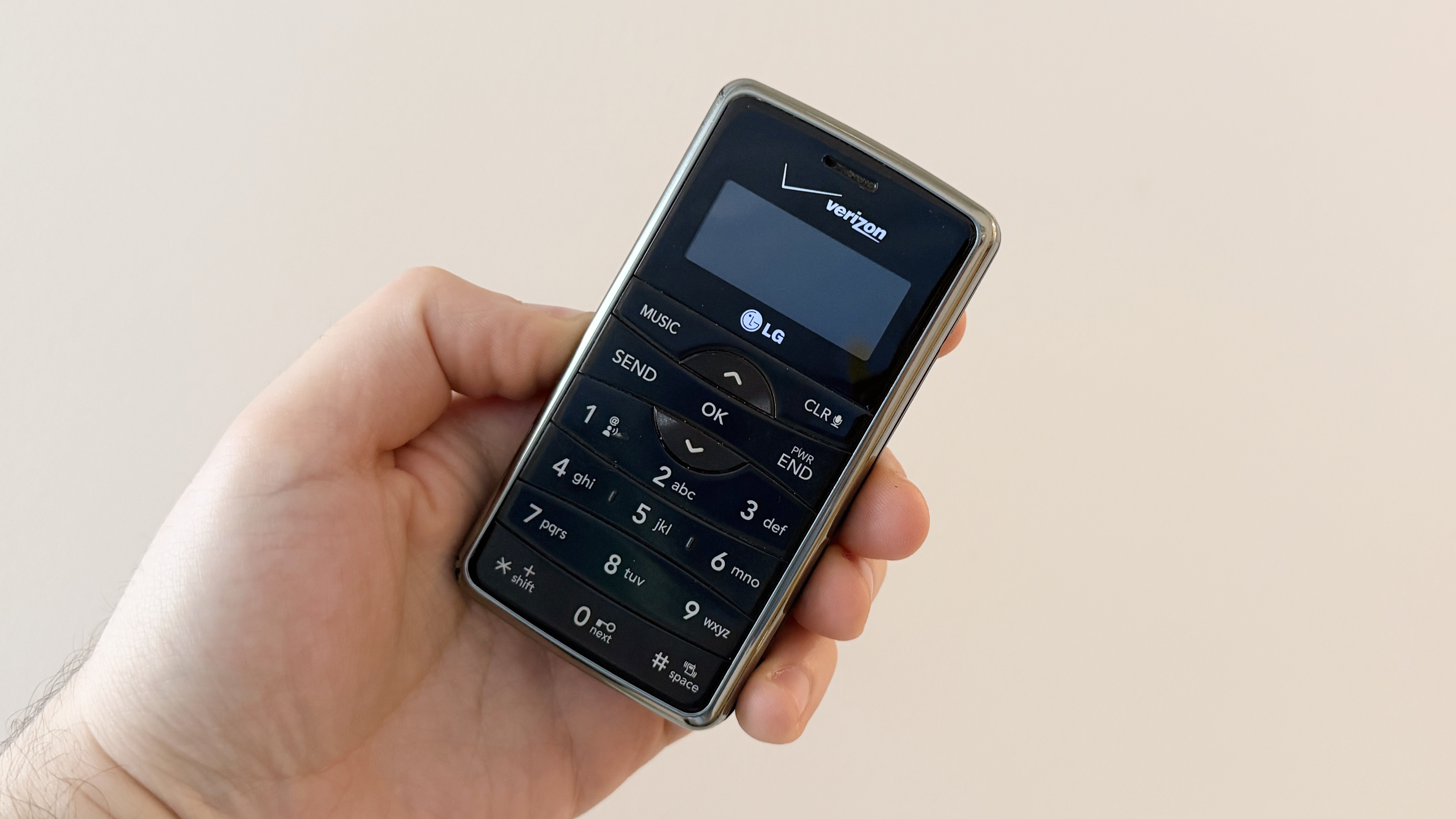 A hand holding the LG enV2 phone