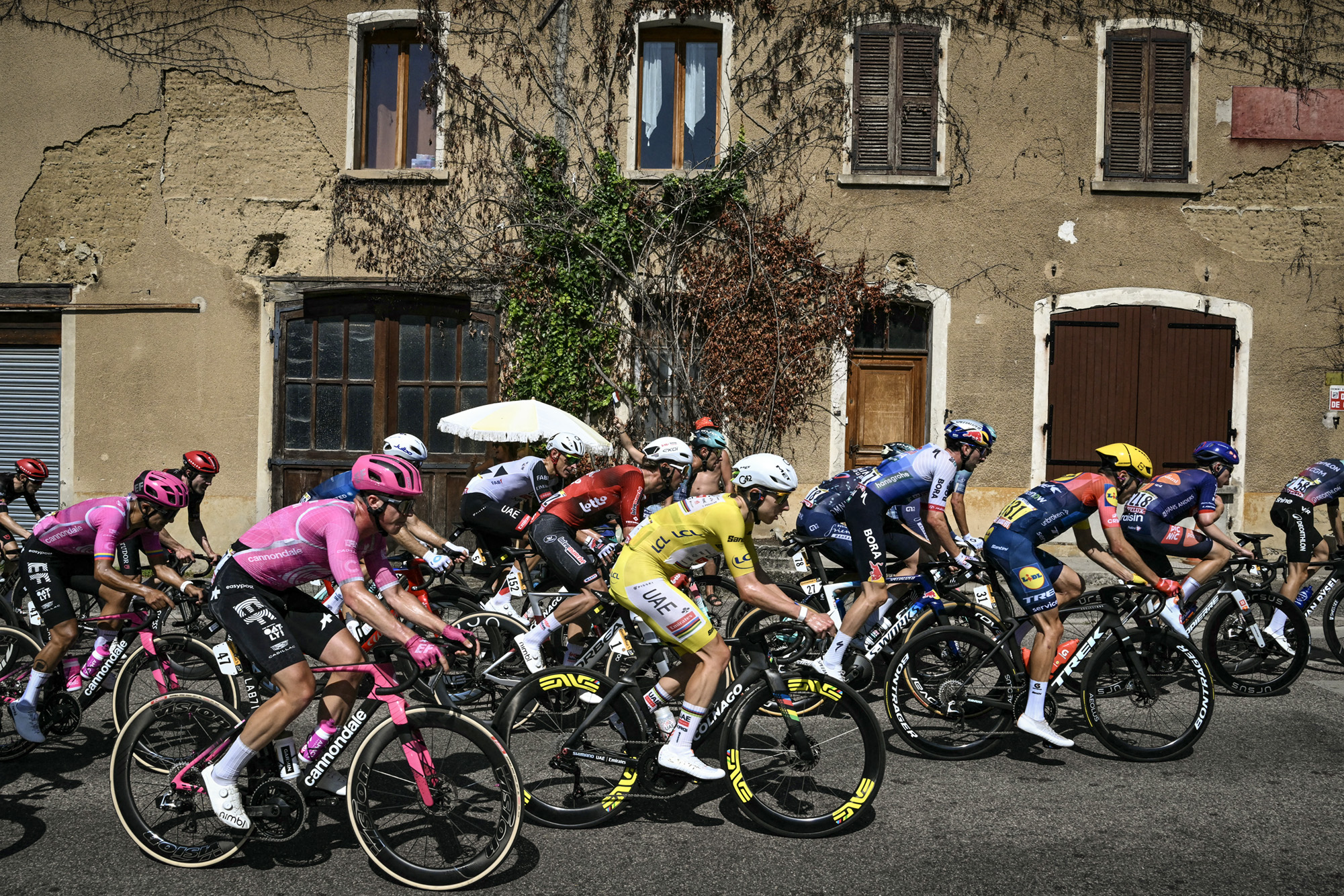 UAE Team Emirates - XRG's Slovenian rider Tadej Pogacar wearing the overall leader's yellow jersey cycles with the pack of riders (peloton) during the 17th stage of the 113th edition of the Tour de France cycling race, 174,7 km between Chamb&eacute;ry and Voiron in the French Alps, on July 22, 2026. (Photo by Jeff PACHOUD / AFP via Getty Images)