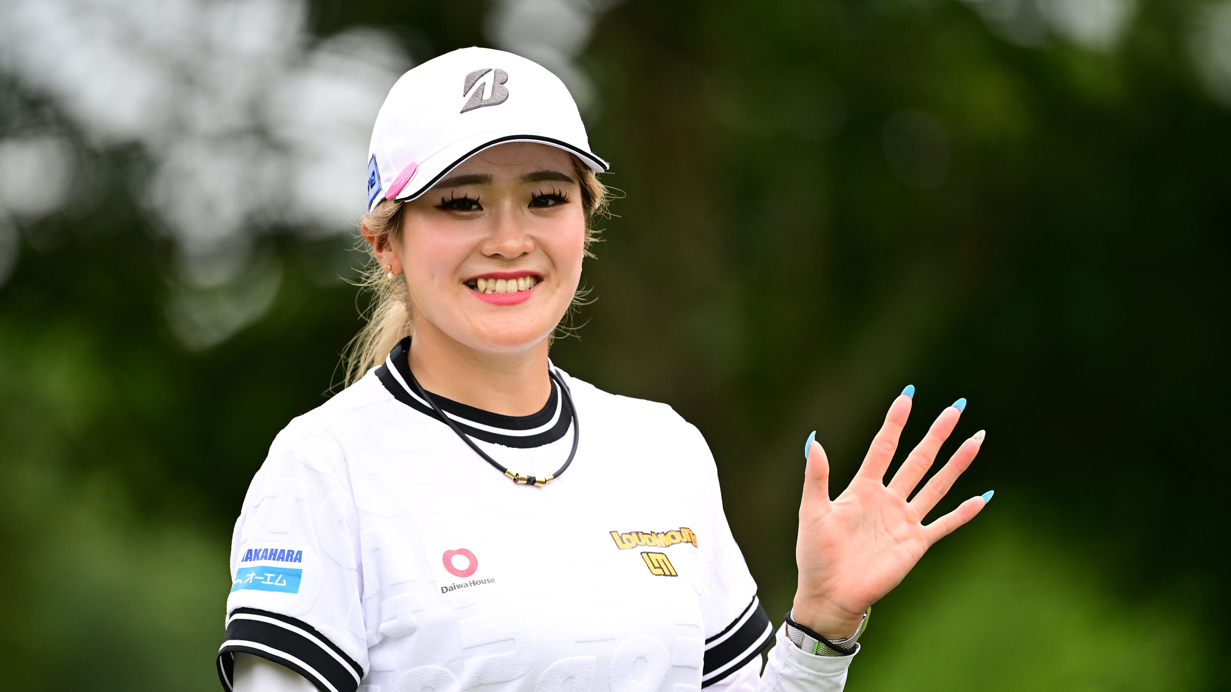 Shiho Kuwaki waves to the camera during the third round of Meijiyasuda Ladies Golf Tournament in July 2026