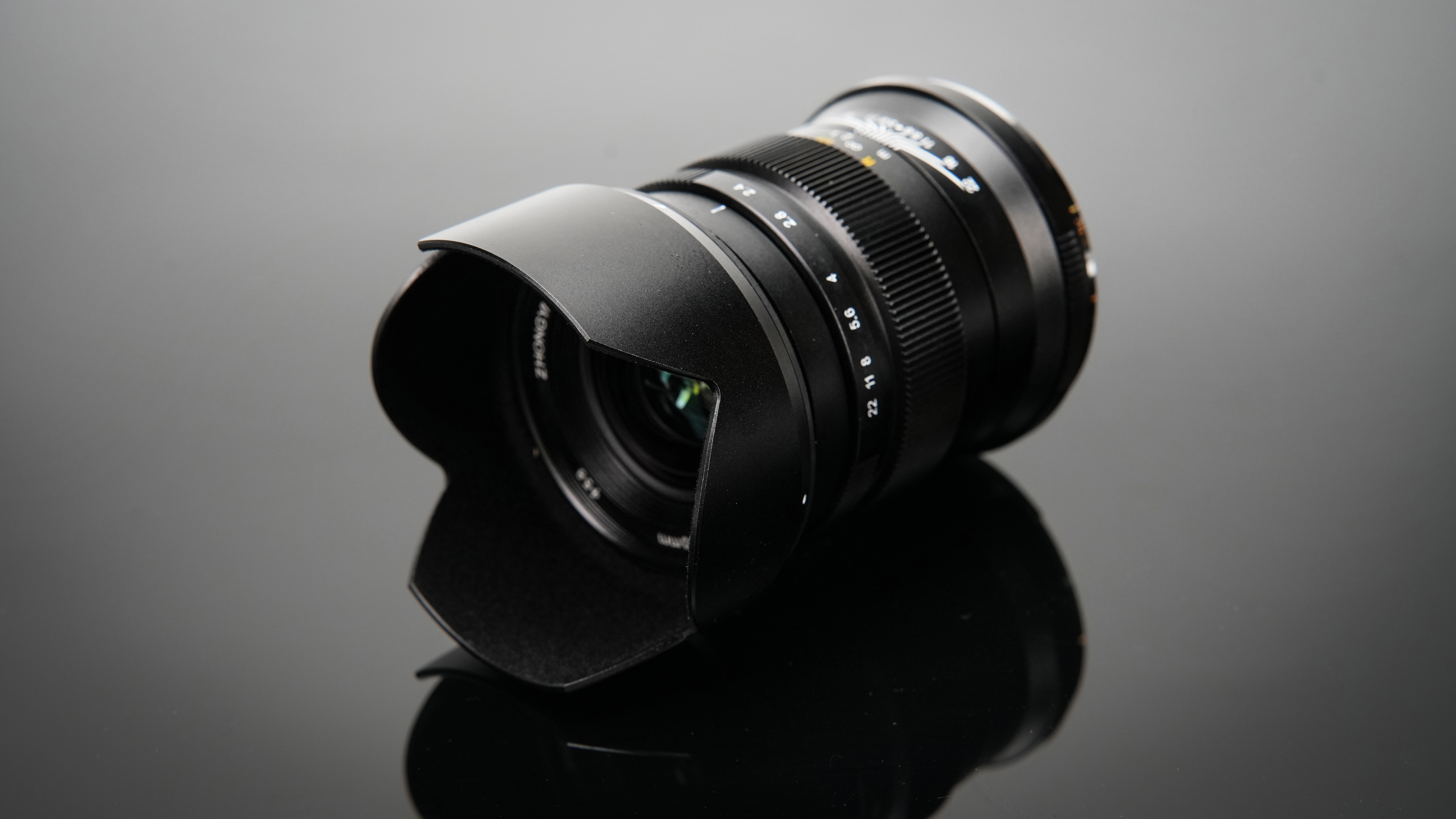 ZY Optics Pittura 30mm f/2.4 lens against a dark background