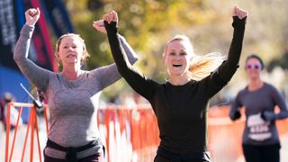 Runners celebrate as they cross the finish line for the Rock n Roll Denver Half Marathon on October 20, 2019