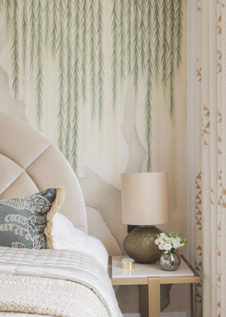 Patterned wallpaper with green trailing leaves falling from the ceiling.