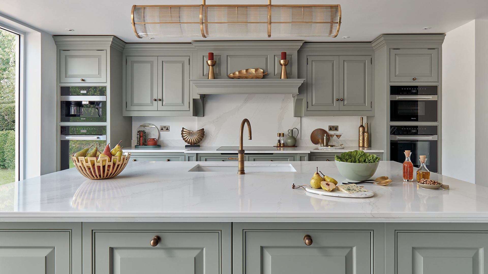 sage green kitchen with brass taps and fittings