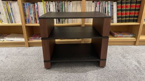 Blok Stax 2G hi-fi rack on grey carpet with vinyl records and bookshelf in behind