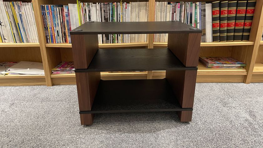 Blok Stax 2G hi-fi rack on grey carpet with vinyl records and bookshelf in behind