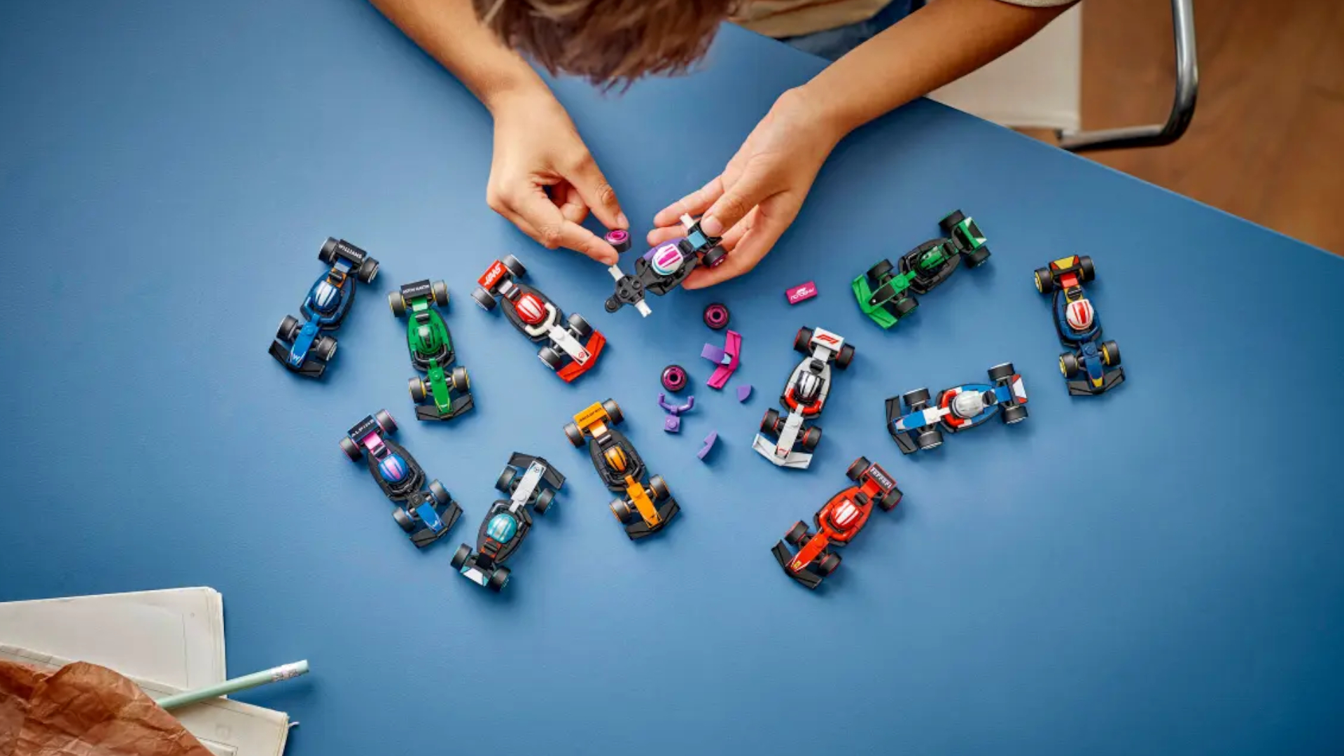 Lego F1 Collectible Race Cars being assembled on a blue table
