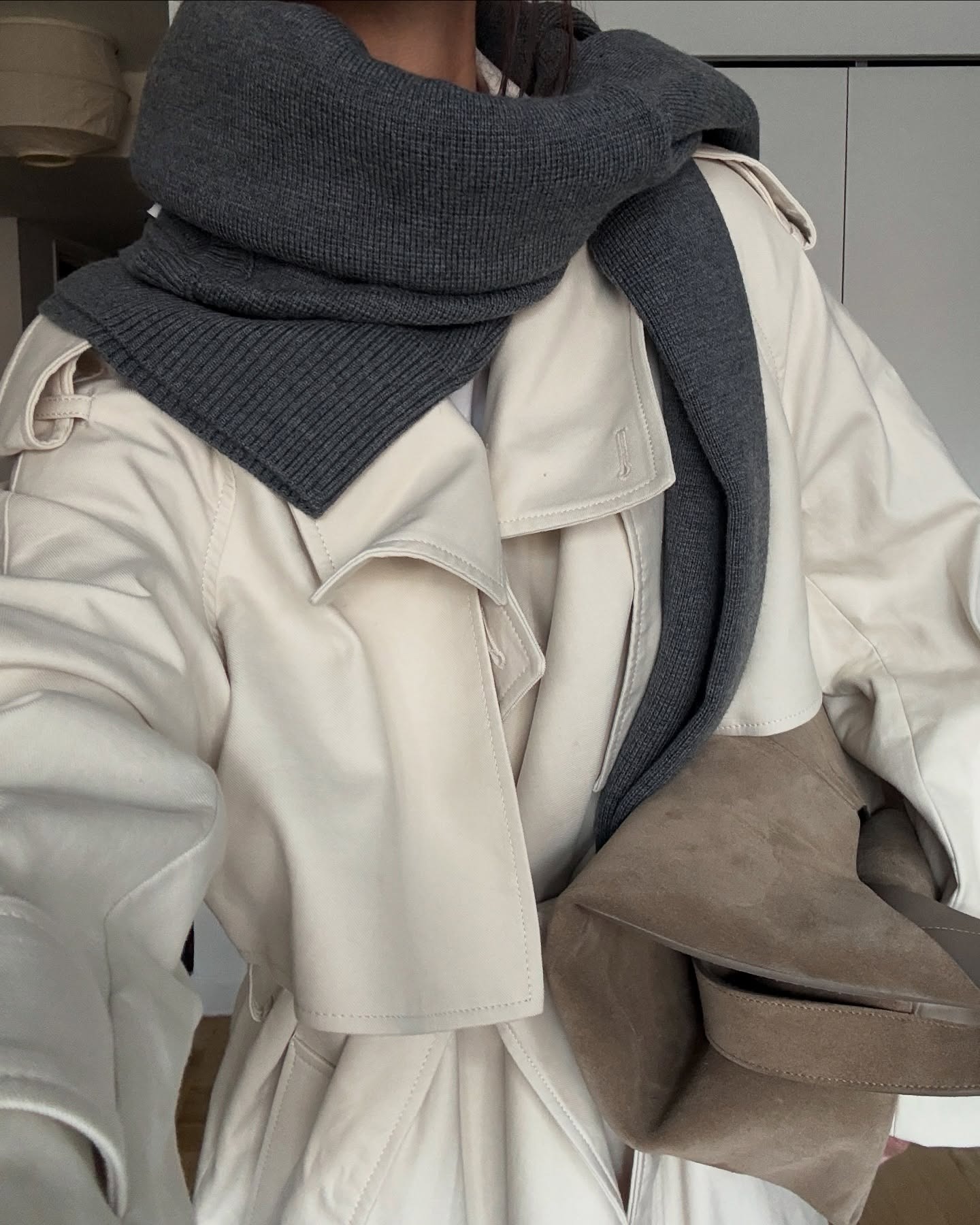 A woman in layers of fall/winter clothes.