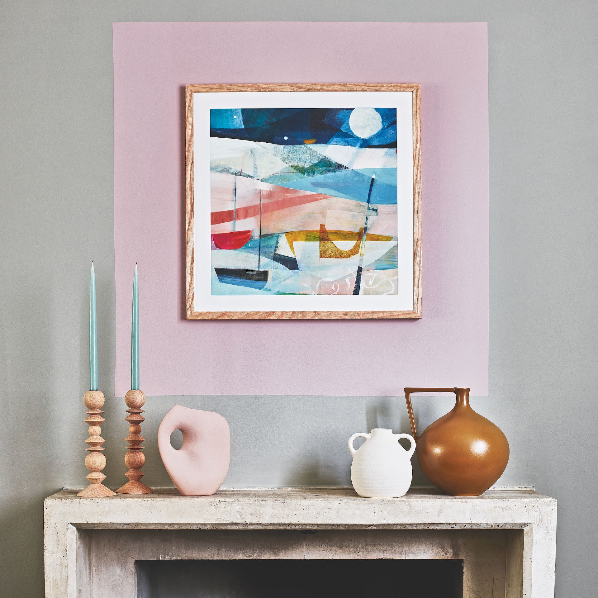 room with frame on wall and candle holders