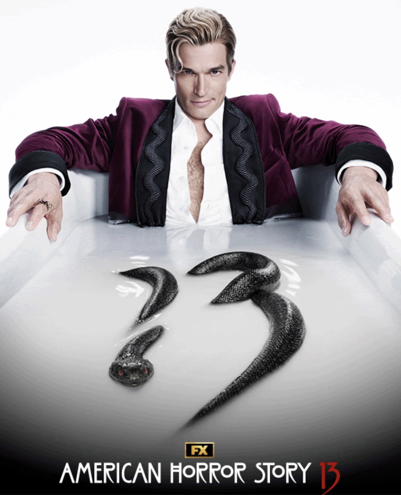 Paul Anthony Kelly's mystery character in purplish smoking jacket and unbuttoned white shirt, sitting inside a bathtub full of white water with snake forming the number 13 in American Horror Story 13