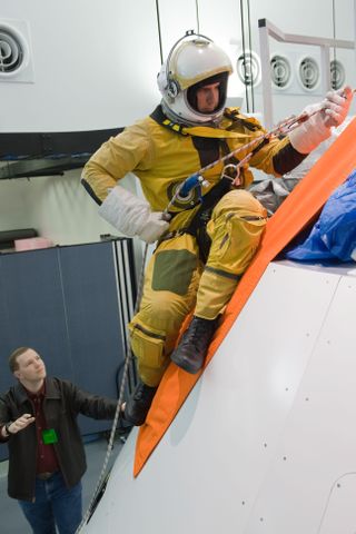 Lockheed Martin engineers test emergency escape procedures from NASA's new Orion capsule at the the Exploration Development Lab in Houston.