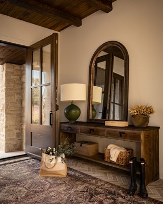 A neutral entryway with dark wood accents