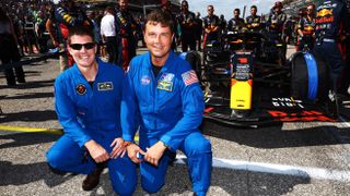 Reid Wiseman and Jeremy Hansen pose for a photo on the grid prior to the F1 Grand Prix of United States at Circuit of The Americas on October 22, 2023 in Austin, Texas.