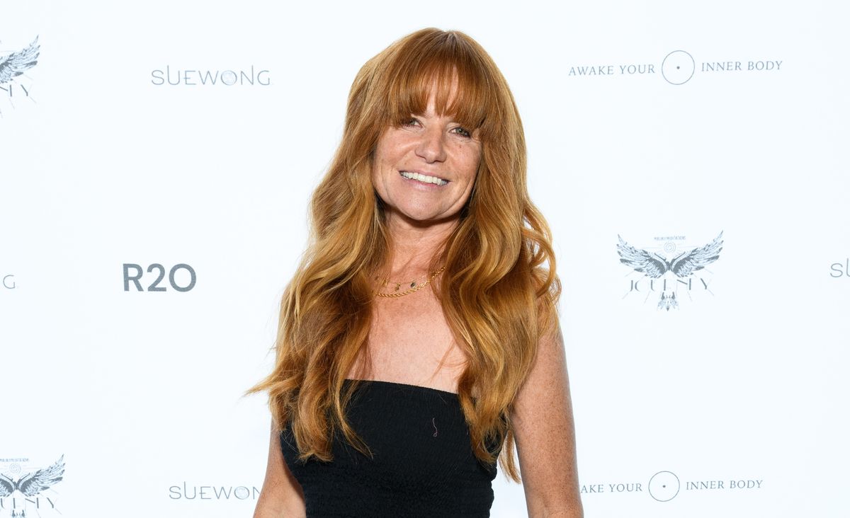 Patsy Palmer on the red carpet wearing a black dress