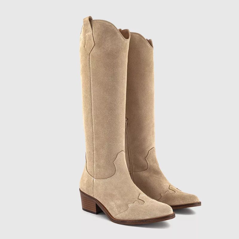 A cutout of beige suede cowboy boots