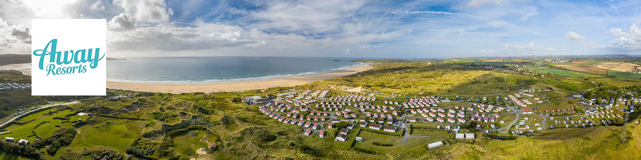 Away resorts logo placed over a panoramic shot of a coast