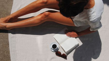 High angle view of a woman reading a book on a holiday