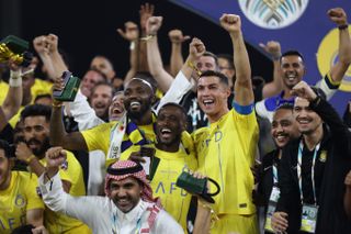 Cristiano Ronaldo celebrates with his Al-Nassr team-mates after victory over Al-Hilal in the Arab Club Champions Cup final in August 2023.